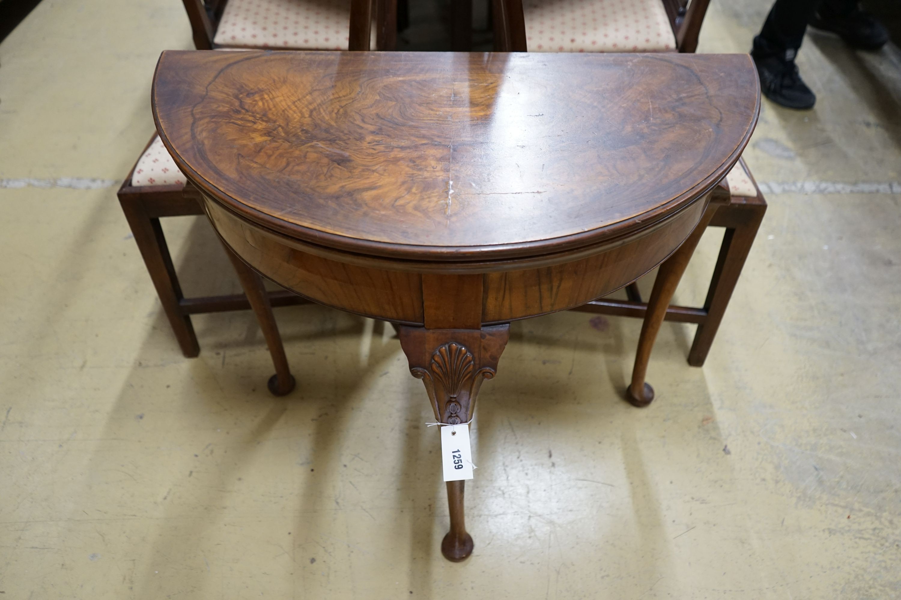 A Queen Anne revival walnut demi-lune folding card table, width 76cm, depth 38cm, height 76cm